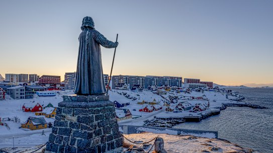 A statue commemorating Hans Egede, the Danish missionary who founded Nuuk in 1728, stands on a hill overlooking the town in Greenland.