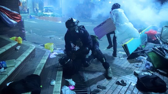 A policeman detains a protester outside of Hong Kong Polytechnic University as police storm the campus  on November 18.