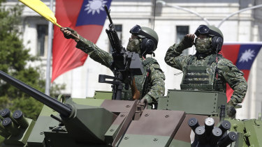 Taiwanese soldiers salute during National Day celebrations in front of the Presidential Office Building in Taipei in October. 