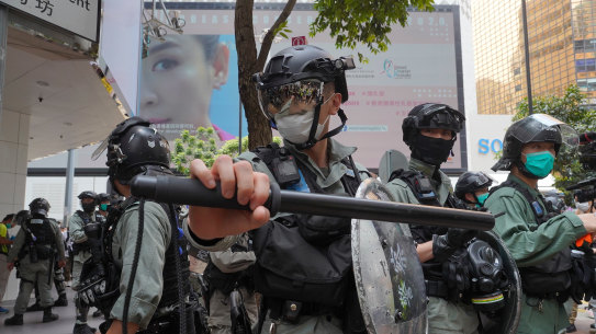 Riot police form a line as they plan to clear away people gathered in the Central district in Hong Kong on Wednesday. 