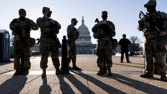 Members of the Michigan National Guard and the US Capitol Police keep watch as heightened security remains in effect around the Capitol. 