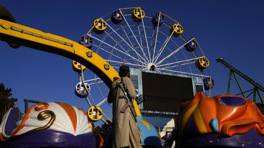 A Taliban fighter stands guard in an amusement park, in Kabul, Afghanistan, on Thursday. Women are now banned from parks and gyms as well.