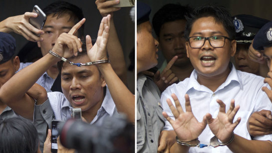 Reuters journalists Kyaw Soe Oo, left, and  Wa Lone, are handcuffed as they are escorted by police out of the court on Monday.