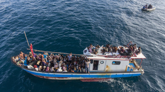 A boat carries ethnic-Rohingya off North Aceh, Indonesia, on June 24.