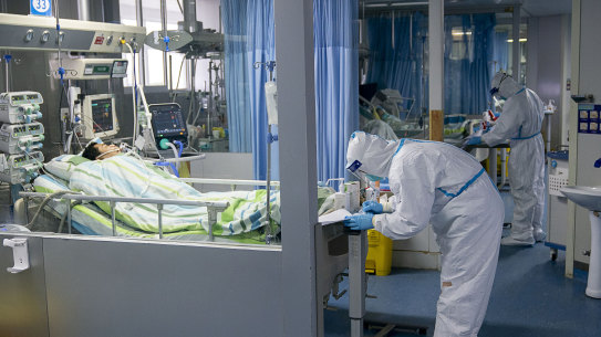 In this piture released by China's Xinhua News Agency, a medical worker attends to a patient in the intensive care unit at Zhongnan Hospital of Wuhan University in Wuhan in central China's Hubei Province. 