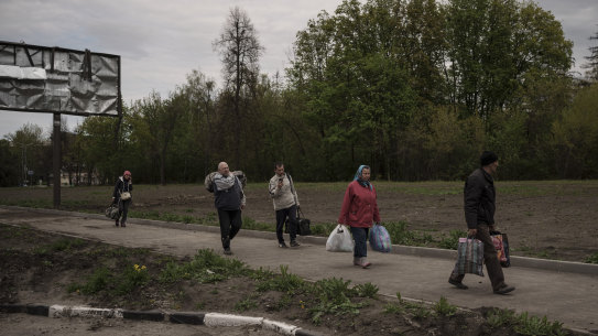 People fleeing the village of Ruska Lozova arrive at a screening point in Kharkiv.