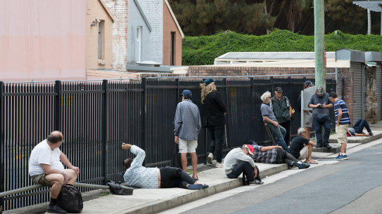 Struggling Sydneysiders line up for a free lunch outside Matthew Talbot Hostel in Woolloomooloo.