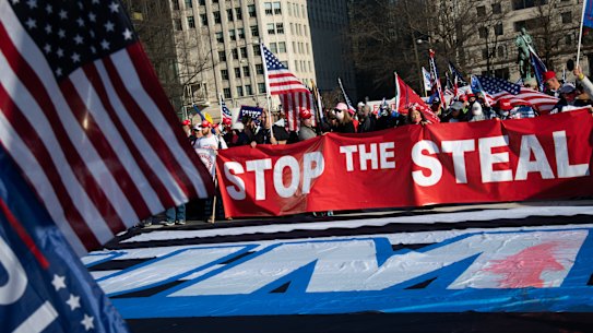 Demonstrators hold a “Stop The Steal” banner in Freedom Plaza during the “Million MAGA March” in Washington, DC weeks before the assault on the Capitol.