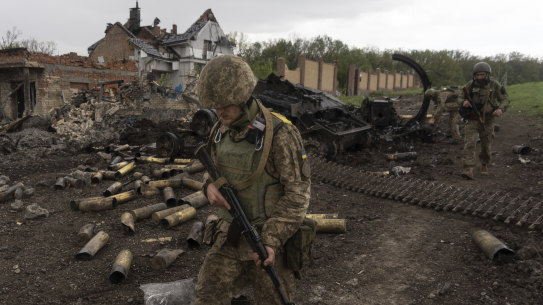 Ukrainian servicemen patrol in a recently retaken village, north of Kharkiv, east Ukraine, on Sunday. 
