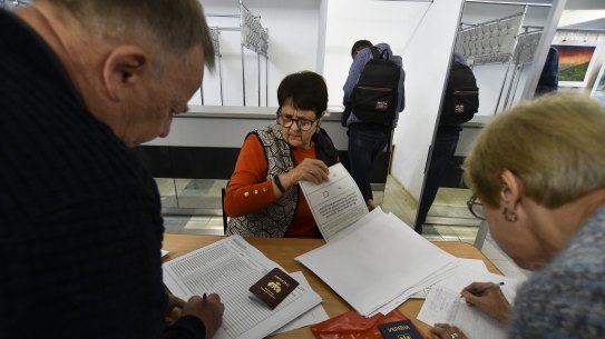 People from Luhansk and Donetsk regions, the territory controlled by a pro-Russia separatist governments, who live in Crimea, get their ballots to vote in a referendum in Sevastopol, Crimea.