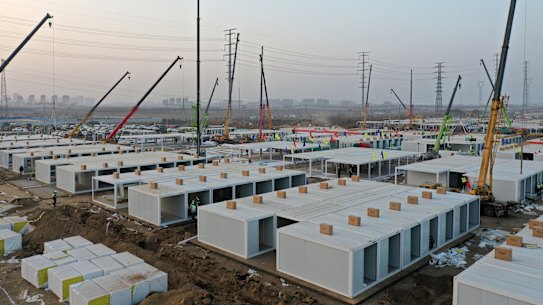 Workers build a large centralised quarantine facility capable of holding several thousand people in Shijiazhuang in northern China's Hebei Province. China on Saturday finished building a 1500-room hospital for COVID-19 patients in Nangong, south of Beijing in Hebei Province, to fight a surge in infections.
