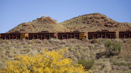 A Rio Tinto iron ore train cuts through the Pilbara landscape.