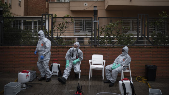 Ffirefighters wearing protective suits wait outside a nursing home before disinfecting it in efforts to prevent the spread of the new coronavirus in Barcelona, Spain, Monday, March 30, 2020. Governments in Europe's hardest-hit countries have yet to systematically test the residents of nursing homes or those who receive in-home care. In Spain, Italy and France, which together account for a third of the world's confirmed coronavirus cases, no one knows for sure how many people have become sick and died of coronavirus, especially among the elderly. The new coronavirus causes mild or moderate symptoms for most people, but for some, especially older adults and people with existing health problems, it can cause more severe illness or death. (AP Photo/Felipe Dana)