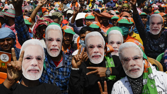 Bharatiya Janata Party (BJP) supporters wear masks of Prime Minister Narendra Modi.