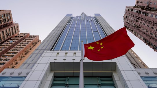 The Chinese flag flutters in the breeze outside China's liaison office building in Hong Kong.