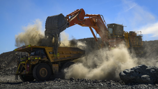 Lithium ore is loaded into mining trucks inside the quarry at the Pilbara Minerals. 