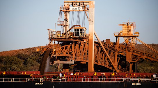 Iron ore is deposited into one of the holds of a cargo ship at BHP’s facilities at Finucane Island in Port Hedland. 