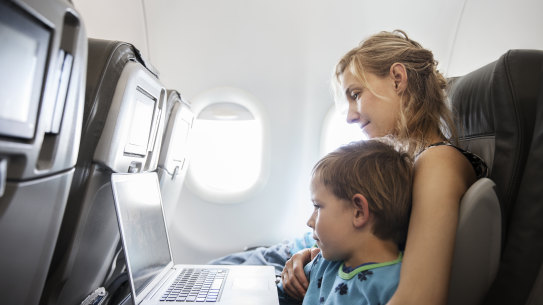 Australians must cut their overseas holidays to help reduce emissions, the IEA says.