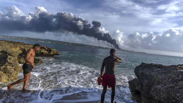 Fire rages at Cuba oil terminal, third tank collapses