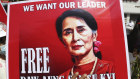 A protester holds a sign demanding Myanmar’s elected civilian leader Aung San Suu Kyi be freed.