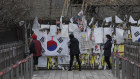 Business as usual. Visitors near the border between North and South Korea add to messages and flags of re-unification hope. There is still no official word on Kim's health.