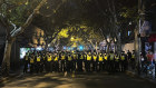 Chinese police officers block off access to a site where protesters had gathered in Shanghai on Sunday.