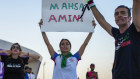 A woman holds up a sign reading Mahsa Amini, who died while in police custody in Iran at the age of 22, during a protest after the World Cup match between Wales and Iran in Qatar.