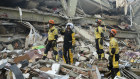 Chinese rescuers looks at a collapsed building before conducting a search and rescue operation in the aftermath of an earthquake in Mandalay, Myanmar. 