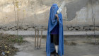  An Afghan woman poses for a photo with her cricket bat in Kabul in 2022.