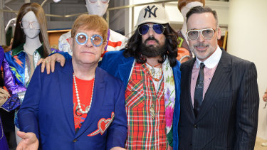 Michele with Elton John and John’s partner David Furnish at a Gucci launch in London. “He’s just very down-to-earth,” John says of the designer.