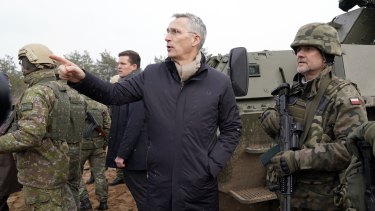 NATO Secretary General Jens Stoltenberg gestures while speaking to Poland’s troops during his visit to Adazi Military base in Kadaga, Latvia.