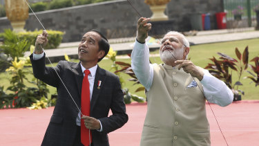 Indonesian President Joko Widodo, left, flies a kite with Indian Prime Minister Narendra Modi during the India-Indonesia kite exhibition in Jakarta.