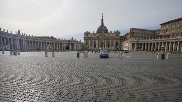 A police car is parked inside an empty St Peter's Square as Italy entered a nationwide lockdown on Thursday.