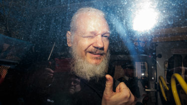 Julian Assange gestures to media from a police vehicle on his arrival at Westminster Magistrates court in April.
The Ecuadorian Embassy in London had withdrawn his asylum after seven years.