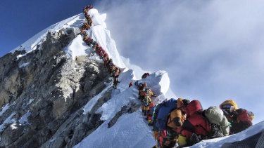Climbers line up in the attempt to reach the peak of Mount Everest. 