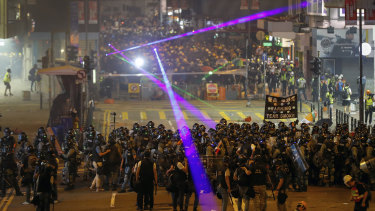 Protesters flash laser beams at police during an anti-extradition protest in Hong Kong on Sunday.