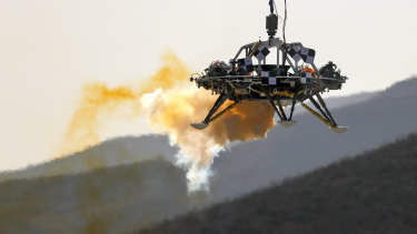 A lander is lifted during a test of hovering, obstacle avoidance and deceleration capabilities of a Mars lander at a facility in Huailai in China’s Hebei province. 