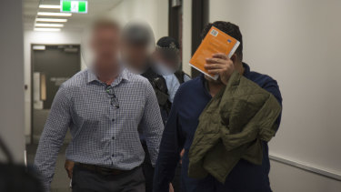 Maythem Radhi is taken into custody at Brisbane Airport.