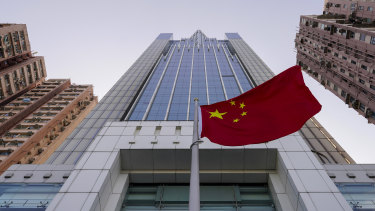 The Chinese flag flutters in the breeze outside China's liaison office building in Hong Kong.