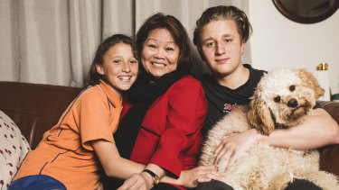 Mila Angcon with two of her grandchildren Rebecca, 12, and Riley, 15, and their dog Malakai. 