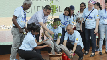 Malaysian Minister of Transport Anthony Loke, third from left, plants a tree at the Day of Remembrance event in Kuala Lumpur.