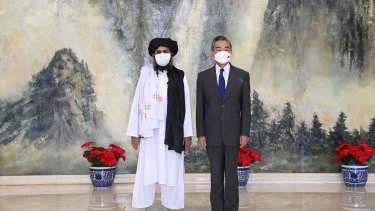 In July, Taliban co-founder Mullah Abdul Ghani Baradar, left, and Chinese Foreign Minister Wang Yi pose for a photo during their meeting in Tianjin, China. 