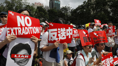 Protesters hold placards during the protests in Hong Kong. 