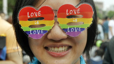 A supporter of LGBT and human rights groups wears rainbow glasses during a rally to support the bill in 2016.