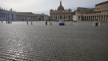 A police car is parked inside an empty St Peter's Square as Italy entered a nationwide lockdown on Thursday.