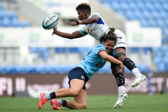 Ema Adivitaloga tackled by NSW's Katrina Barker - but not without an offload.