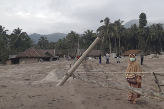 A women walks in an area affected by the eruption of Mount Semeru in Lumajang, East Java.