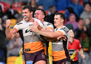 Corey Oates celebrates one of his two tries against Manly on Friday night.