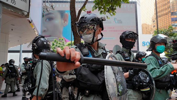 Riot police form a line as they plan to clear away people gathered in the Central district in Hong Kong on Wednesday. 