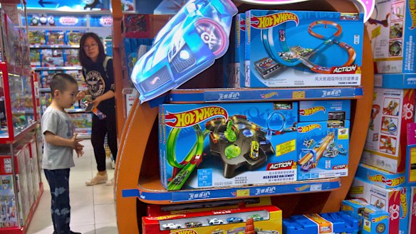 A boy looks at a display for Hot Wheels cars made by American toymaker Mattel at a toy store in Beijing. For many Chinese and Americans Donald Trump's trade war may soon get very real.